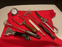 Group shot of all seven utensils on red cloth