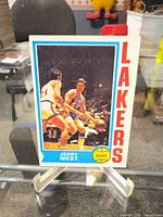 Front of Jerry West Topps card on stand