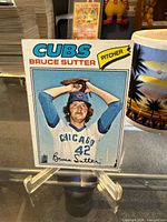 Front of 1977 Topps Bruce Sutter #144 card on stand