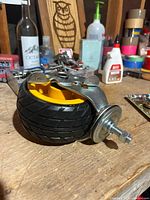 Caster showing wheel tread and threaded stem