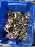 Overview of blue tote full of mixed hardware and C-clamps