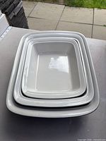 Three nested rectangular baking dishes showing white interiors