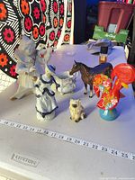 All six porcelain and ceramic pieces on tabletop with measuring scale