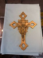 Full view of brass crucifix on cloth