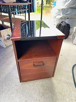 Front view of nightstand showing open shelf and drawer closed