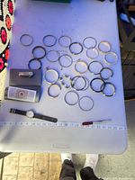 Top view of all bangles, watch, lighter in case on table