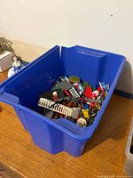 Blue bin containing assorted loose building bricks