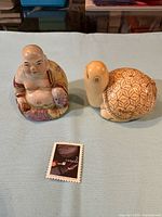 Both figures side by side with postage stamp for scale