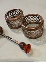 Two 800 silver pierced napkin rings and EPNS spoon overview