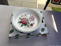Pie dish sitting on original box, showing floral motif and size context