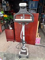 Front view of Rowenta garment steamer with hanger and base visible