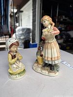 Both figurines side by side on table