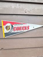 Full view of Vancouver Canucks felt pennant on wall