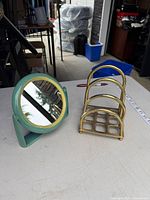 Mirror and brass napkin holder on table
