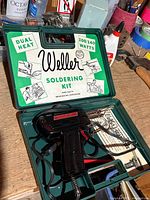 Open case showing soldering gun, tips, paperwork