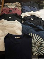 All 11 t-shirts laid out showing colours and styles