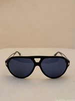 Front view of sunglasses showing navy frame and blue lenses