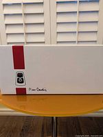 sealed white retail box with red stripe and Pierre Cardin logo