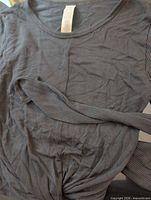 Front view of Alo shirt showing fabric and tie detail