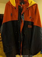 Front view of navy and red Fila Sport jacket on hanger