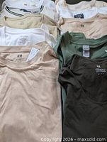 Close-up of central shirts displaying H&M and Gildan tags