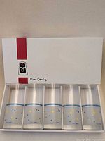 Box opened showing five glasses in individual slots