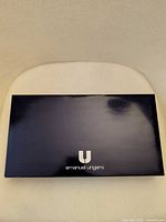 Closed black presentation box with Emanuel Ungaro branding