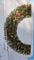 Box image showing full wreath lit and decorated