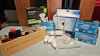 Overview of all boxed LED bulbs, loose bulbs, clear bulb pack and wooden crate with shoe polish items