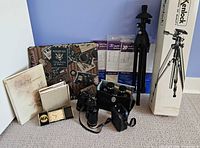 Group shot showing tripod box, binoculars, photo albums, refill pages