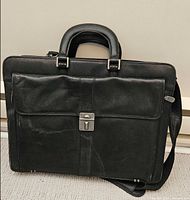 Front of black leather Mancini briefcase with lock clasp and strap