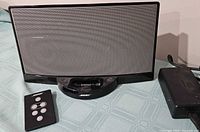 Front view of Bose SoundDock speaker dock with remote and power adapter