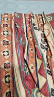 Close-up of fabric front showing multicolour pattern and pleats