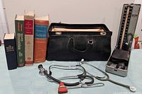 Overall lot showing doctor’s bag, medical instruments and four books