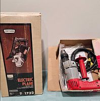 Craftsman planer box beside open Milwaukee drill box showing tool and contents