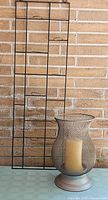 Full view of both items: wall candle rack and mesh hurricane