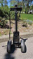 Front view showing two wheels, frame, and strap