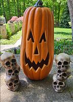 Pumpkin with two skull stacks on patio