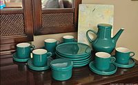 Complete set displayed: coffee pot, sugar bowl, 6 cups with saucers, 6 dessert plates