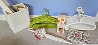 Group shot showing both sets of hangers, umbrella, diffuser box, wastebasket with rolls, and floral storage box