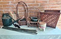 Overview of watering can, planter, pots, stakes, twig decor, tools and paint