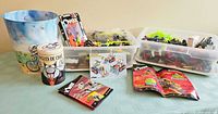 Overview showing two totes of K'NEX parts, manuals, wastebasket and tin