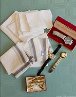 Group view of watches, handkerchiefs and cufflinks
