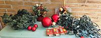 Tabletop view with garland, floral arrangement, ornaments, string lights and bulb packs