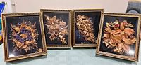 Front view of four matching 12" x 10" framed dried flower pictures under glass