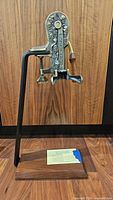 Front view of Rogar Estate countertop wine opener on stand and wooden base