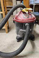 Full view of Shop-Vac canister with hose attached
