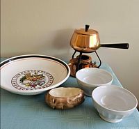 All items grouped: copper fondue set, pasta bowl, two white bowls, oval potato dish