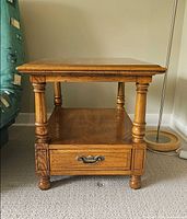 Front view showing entire end table, shelf, drawer, legs