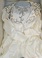 Dress and jacket inside storage box showing beadwork detail
